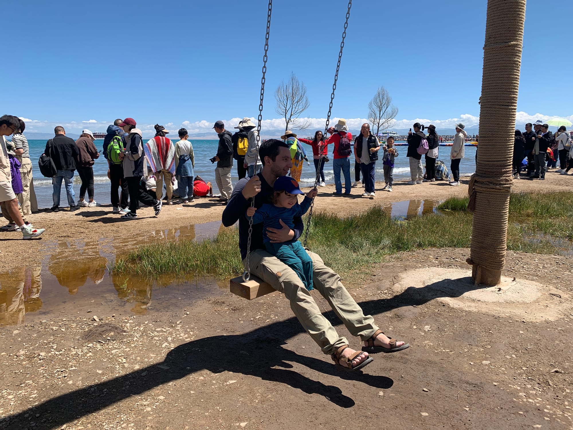 Qinghai Lake panoramic view with grasslands and blue sky in western China