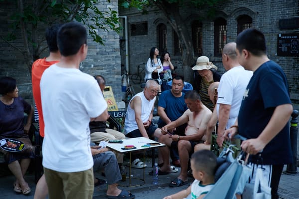 People playing card games in a Beijing Huton